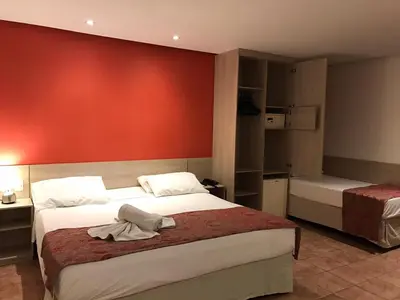 Uma cama ou camas num quarto em Plaza Praia Suítes