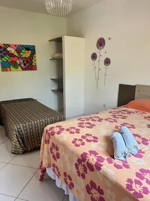 Uma cama ou camas num quarto em Pousada da Lucinha
