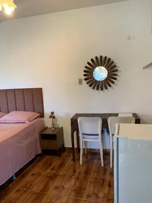 Uma cama ou camas num quarto em Pousada da Lucinha