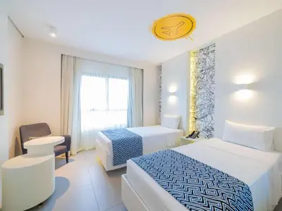 Uma cama ou camas num quarto em Golden Tower Maracanaú by Fênix Hotéis