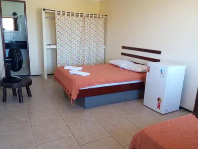 Uma cama ou camas num quarto em Pousada e Pizzaria Sol e Alegria