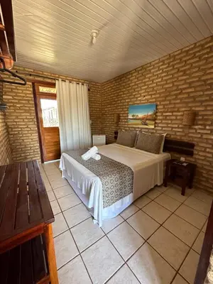 Uma cama ou camas num quarto em Pousada Catavento