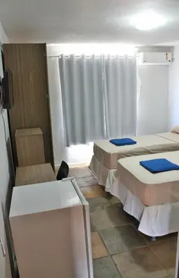 Uma cama ou camas num quarto em Pecém Hotel