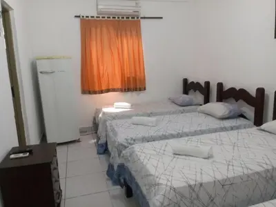 Uma cama ou camas num quarto em Pousada Casa da Lucinha