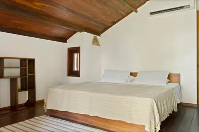 Uma cama ou camas num quarto em Pousada Pais Tropical