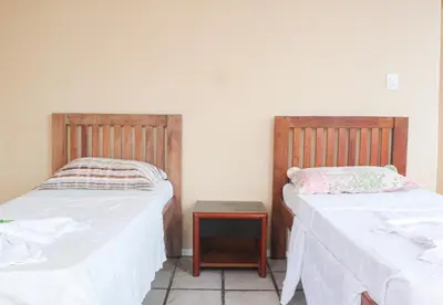 Uma cama ou camas num quarto em Pousada Mucuripe