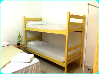 Uma cama ou camas num quarto em Hospedaria Praia e Sol