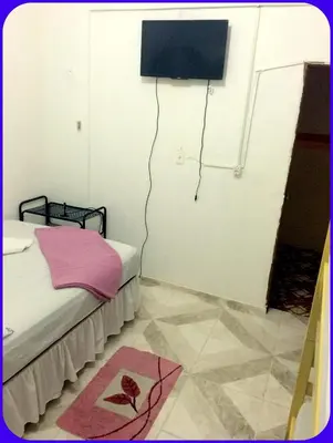 Uma cama ou camas num quarto em Hospedaria Praia e Sol