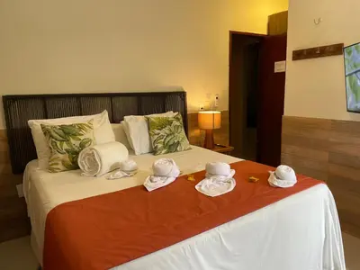 Uma cama ou camas num quarto em Pousada Monteflor Guaramiranga-CE