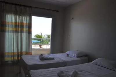 Uma cama ou camas num quarto em Brisa Mar