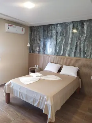 Uma cama ou camas num quarto em Pousada e Restaurante Lagoa Azul