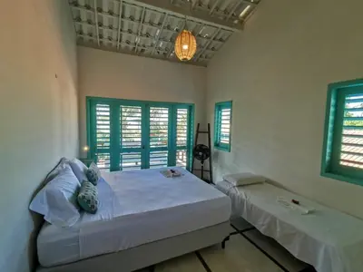 Uma cama ou camas num quarto em La Villa Tropicale linda casa pertinho do mar !