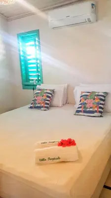 Uma cama ou camas num quarto em La Villa Tropicale linda casa pertinho do mar !