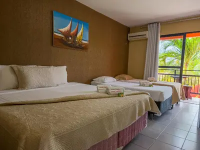 Uma cama ou camas num quarto em Pousada Brasil Cumbuco