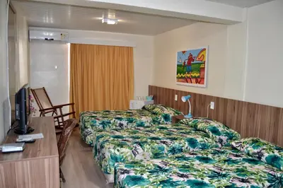 Uma cama ou camas num quarto em Hotel Casa De Praia