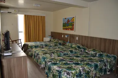 Uma cama ou camas num quarto em Hotel Casa De Praia