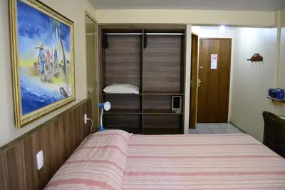 Uma cama ou camas num quarto em Hotel Casa De Praia
