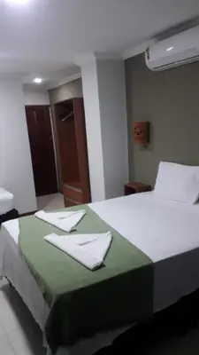 Uma cama ou camas num quarto em Pousada Nova Oasis do Rei