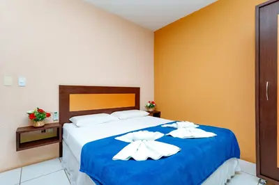 Uma cama ou camas num quarto em Pousada Iguana