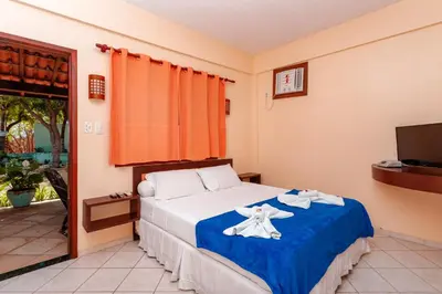 Uma cama ou camas num quarto em Pousada Iguana