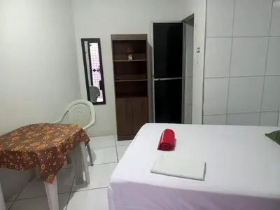 Uma cama ou camas num quarto em Suítes Centro Praia