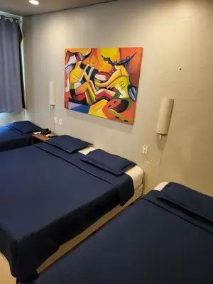 Uma cama ou camas num quarto em Hotel Encontro do Sol