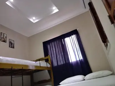 Uma cama ou camas num quarto em Suítes Canaã