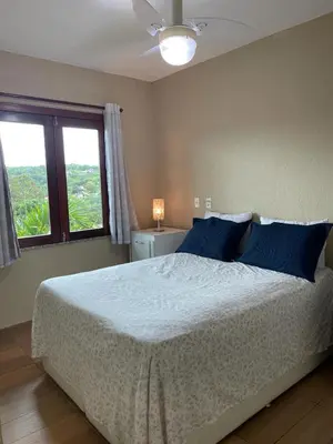 Uma cama ou camas num quarto em Guaramiranga Monte Verde