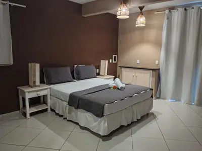 Uma cama ou camas num quarto em Pousada Aruana