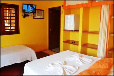 Uma cama ou camas num quarto em Pousada Sahara
