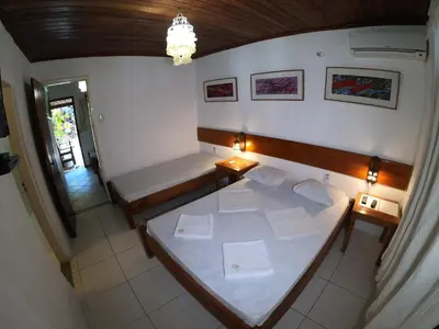 Uma cama ou camas num quarto em Pousada Casa Do Angelo
