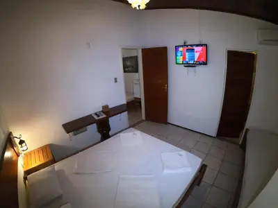 Uma televisão e/ou sistema de entretenimento em Pousada Casa Do Angelo