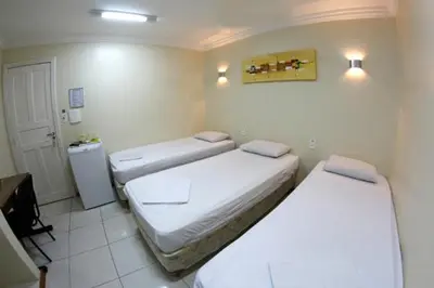 Uma cama ou camas num quarto em Hotel Belem Fortaleza