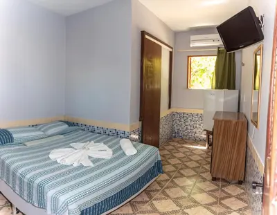 Uma cama ou camas num quarto em Pousada Fortaleza