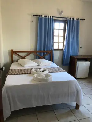 Uma cama ou camas num quarto em Pousada do Holandês