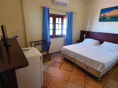 Uma cama ou camas num quarto em Pousada California