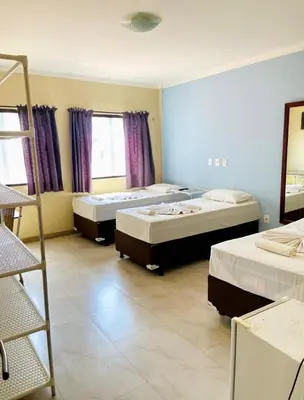 Uma cama ou camas num quarto em Pousada do Toby