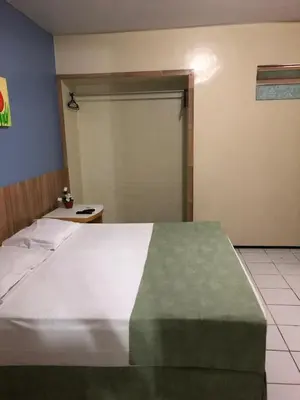 Uma cama ou camas num quarto em Raio de Sol Praia Hotel