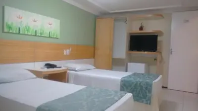 Uma cama ou camas num quarto em Raio de Sol Praia Hotel