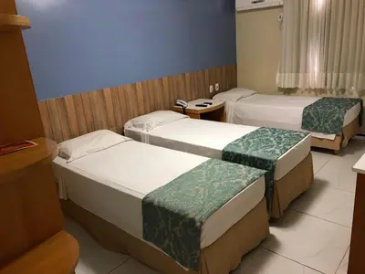 Uma cama ou camas num quarto em Raio de Sol Praia Hotel