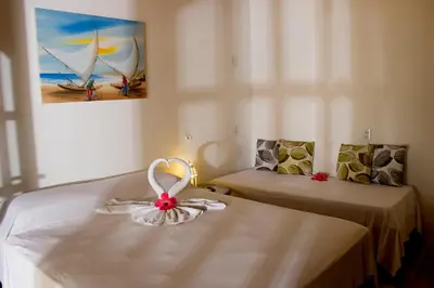 Uma cama ou camas num quarto em Pousada Villa Caju