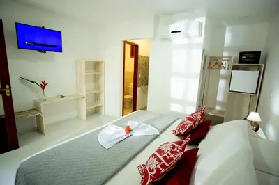 Uma cama ou camas num quarto em Pousada Villa Caju