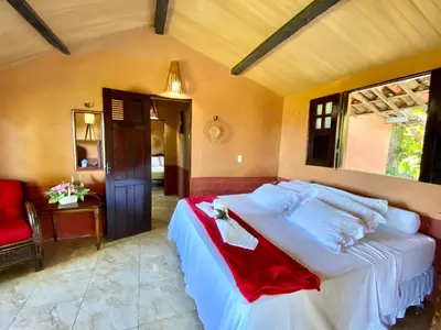 Uma cama ou camas num quarto em Pousada Le Monte Cristo