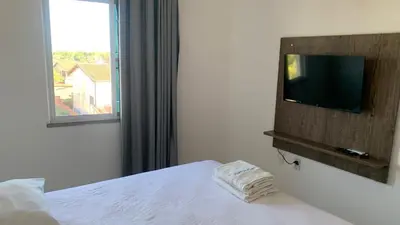 Uma cama ou camas num quarto em Fortal Flat