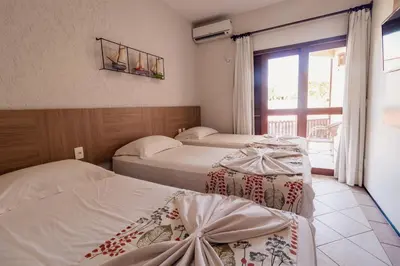 Uma cama ou camas num quarto em Kanaloa Pousada
