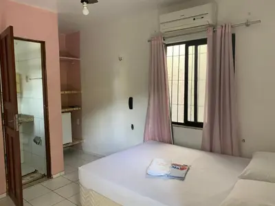 Uma cama ou camas num quarto em Pousada Malu