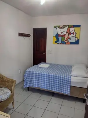 Uma cama ou camas num quarto em Pousada Centro e Praia