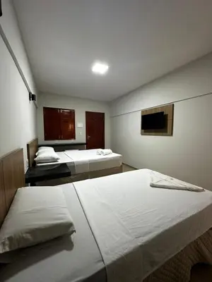 Uma cama ou camas num quarto em Pousada Arco Iris Fortaleza