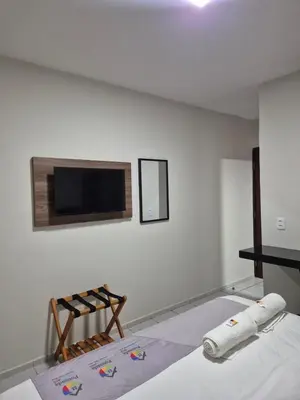 Uma cama ou camas num quarto em Pousada Arco Iris Fortaleza