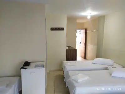 Uma cama ou camas num quarto em Pousada Dragao Do Mar